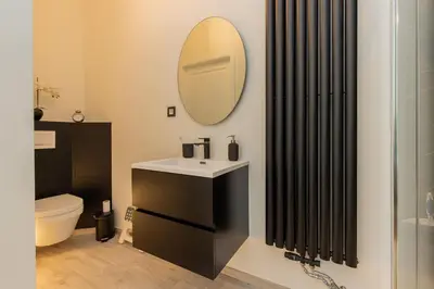 a bathroom with a sink and a mirror at Lily Flower - B&B in Kapelle-op-den-Bos