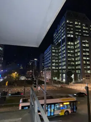 a bus driving down a city street at night at Apartment in Heart of Brussel City with Balcony View in Brussels