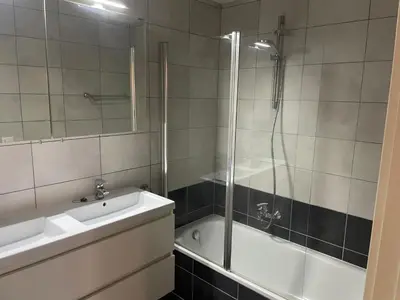 a bathroom with a tub and a sink and a shower at Apartment in Heart of Brussel City with Balcony View in Brussels