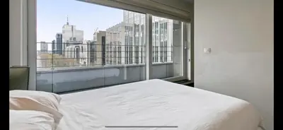 a bedroom with a bed and a large window at Apartment in Heart of Brussel City with Balcony View in Brussels