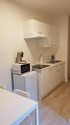 a kitchen with white cabinets and a counter top at B44 appartment in Brussels