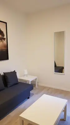 a living room with a couch and a mirror at B44 appartment in Brussels