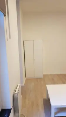 an empty white room with a table and a radiator at B44 appartment in Brussels