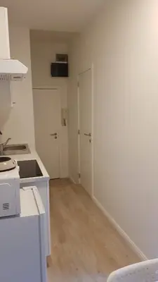 a kitchen with white walls and a counter top at B44 appartment in Brussels