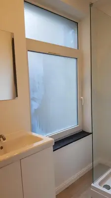 a bathroom with a window and a sink at B44 appartment in Brussels