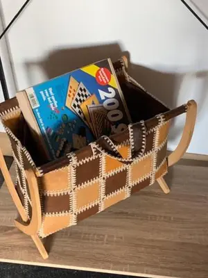 a wooden basket filled with books on a table at Vélo 94 bij Soof in Geel