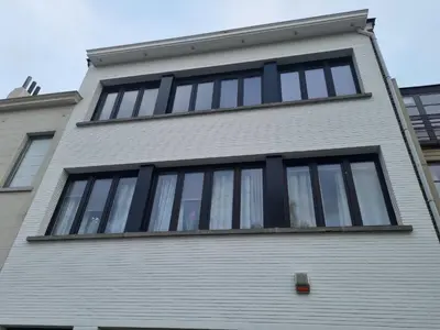 a building with windows on the side of it at BB GUESTHOUSE in Wezembeek-Oppem