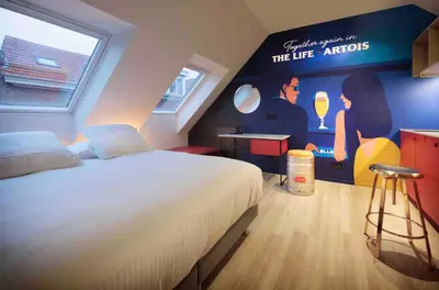 a bedroom with a bed and a painting on the wall at M-Street art lodging - Self check-in in Leuven