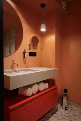 a bathroom with a sink and towels on a shelf at M-Street art lodging - Self check-in in Leuven