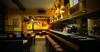 a restaurant with a bar with brown leather chairs at M-Street art lodging - Self check-in in Leuven