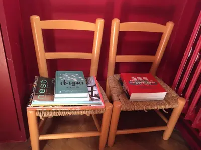 a couple of chairs with books on top of them at Authentieke privé-kamer bij Karen in Beveren