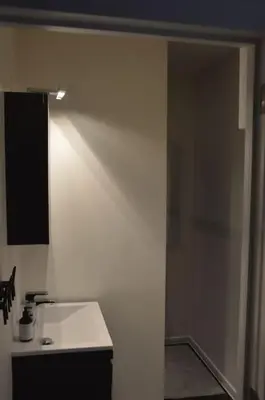 a kitchen with a white counter and a white wall at Hippe studio in historisch gebouw in oude centrum in Antwerp