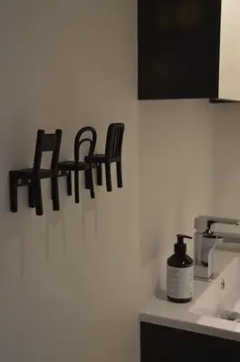 a bathroom with a sink and a sign on the wall at Hippe studio in historisch gebouw in oude centrum in Antwerp