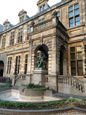 a large building with a statue in front of it at Hippe studio in historisch gebouw in oude centrum in Antwerp