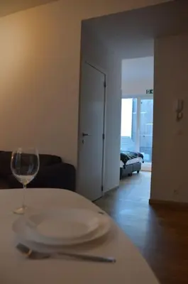 a table with a plate and a wine glass on it at Hippe studio in historisch gebouw in oude centrum in Antwerp