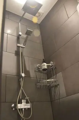 a shower with a shower head in a bathroom at Hippe studio in historisch gebouw in oude centrum in Antwerp