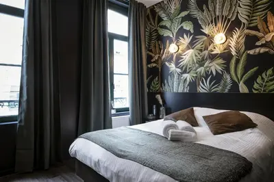 a bedroom with a bed with a floral wallpaper at Secret Walls in Brussels