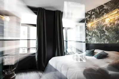 a bedroom with a bed and a large window at Secret Walls in Brussels