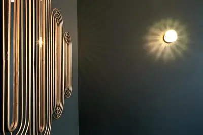 two pictures of a wall with a light at Secret Walls in Brussels