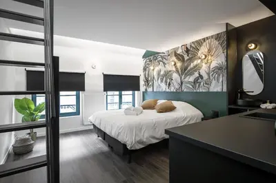 a bedroom with a bed and a sink in it at Secret Walls in Brussels