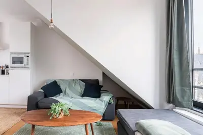 a living room with a couch and a table at New apartment with big terrace and great views! in Leuven