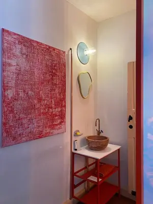 a bathroom with a sink and a large painting on the wall at Bed & Binnekyk in Mechelen