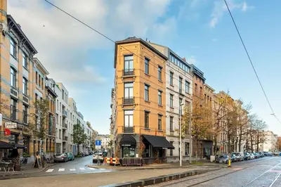 a tall brick building on a city street at Stijlvol duplex appartement in Antwerp