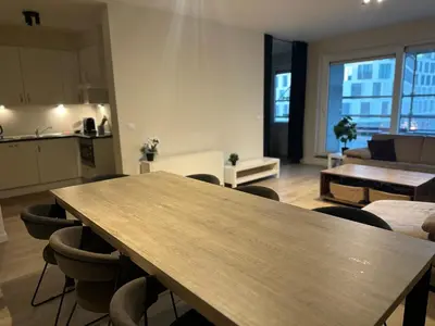 a kitchen and a living room with a table and chairs at Apartment in Brussels City with Beautiful View in Brussels