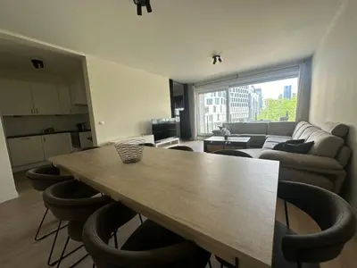 a living room with a wooden table and chairs at Apartment in Brussels City with Beautiful View in Brussels