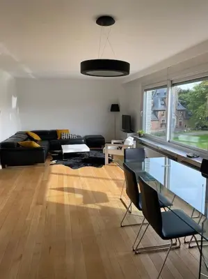 a living room with a couch and a table at Beautiful 3 bedroom Apartment in Antwerp