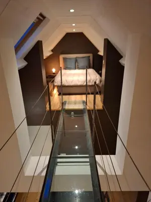 a small bedroom with a bed in the middle of a room at Loft aan Puyenbroeck in Wachtebeke