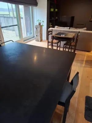a black table and chairs in a living room at Loft aan Puyenbroeck in Wachtebeke