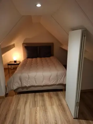 a bedroom with a bed in the attic at Loft aan Puyenbroeck in Wachtebeke