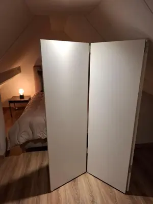 a white closet in a room with a bed at Loft aan Puyenbroeck in Wachtebeke