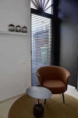 a living room with a chair and a table at Visite in Evergem