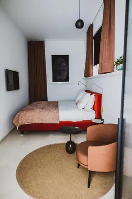 a bedroom with a bed and a chair at Visite in Evergem