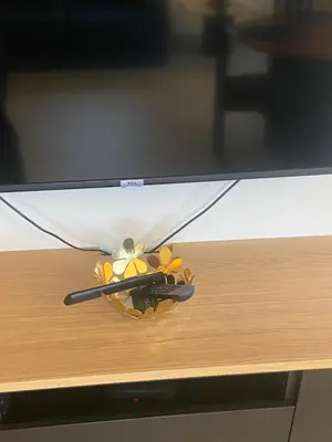 a television screen with a toy on top of a table at La Clé des Champs in Tervuren