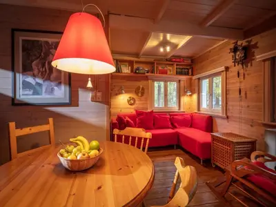 a living room with a red couch and a table at Gierle Garden Bungalow Escape in Lille