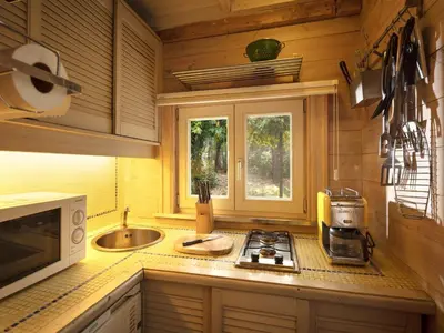 a kitchen with a stove and a sink and a window at Gierle Garden Bungalow Escape in Lille