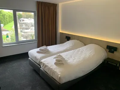 a hotel room with a bed with towels on it at OccO in Willebroek