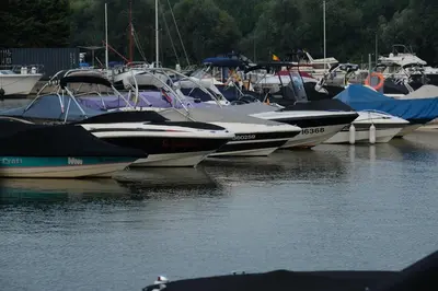 a bunch of boats are docked in the water at OccO in Willebroek