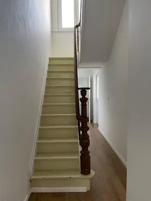 a staircase in a house with a wooden stair case at House between Antwerp and Brussels in Rumst