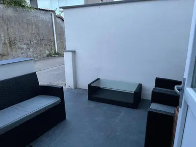 a patio with two chairs and a bench and a table at House between Antwerp and Brussels in Rumst