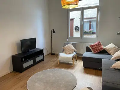 a living room with a couch and a tv at House between Antwerp and Brussels in Rumst