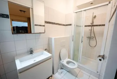 a bathroom with a toilet and a sink and a shower at Apartment with Stunning View in City Center in Brussels