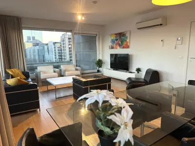 a living room with a couch and a table at Apartment with Stunning View in City Center in Brussels