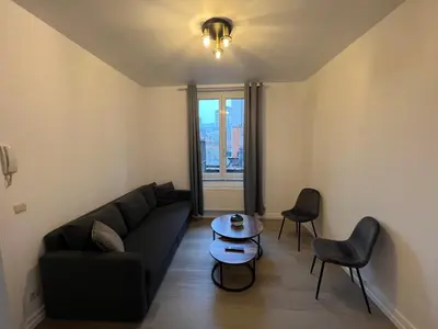 a living room with a couch and a table at Cosy Apartment Merode 2 in Brussels