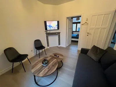 a living room with a couch and a table at Cosy Apartment Merode 2 in Brussels