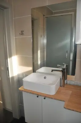 a bathroom with a white sink and a mirror at at Number 1 in Rumst
