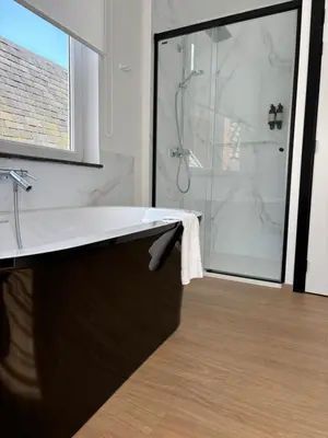 a bathroom with a sink and a shower at Comic Art Hotel in Ghent
